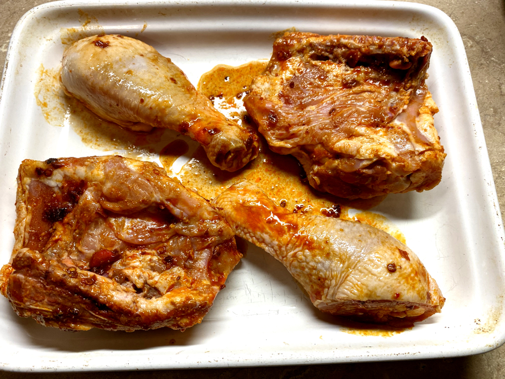 raw chicken on a white baking dish